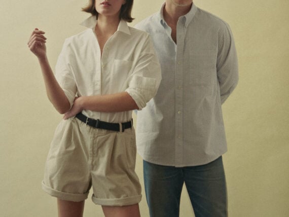 A man and woman in Oxford shirts