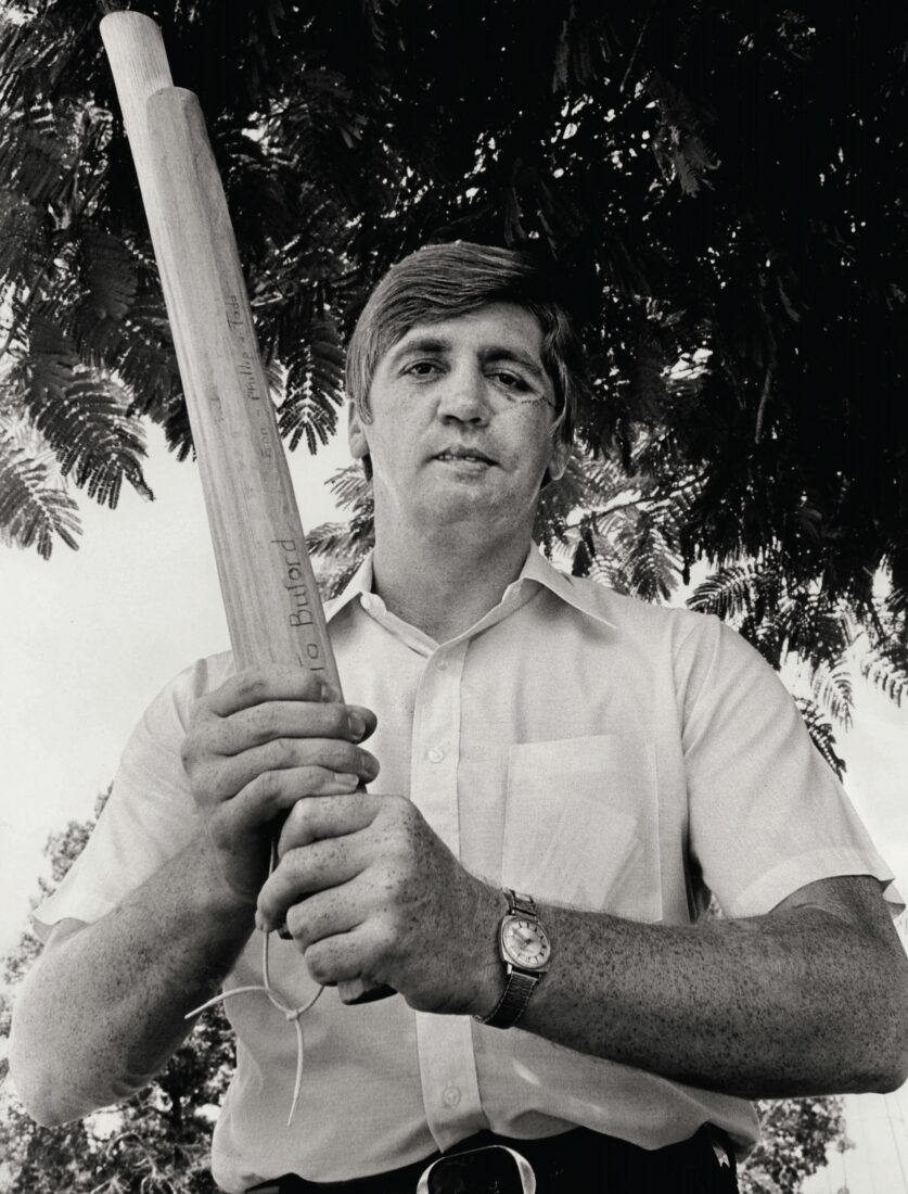 A man holds a stick