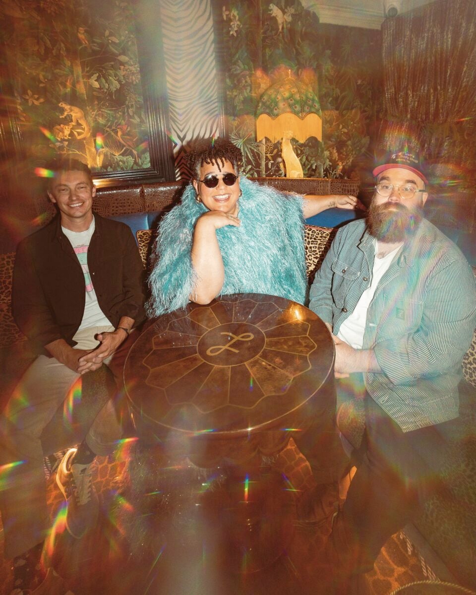 Three people around a table