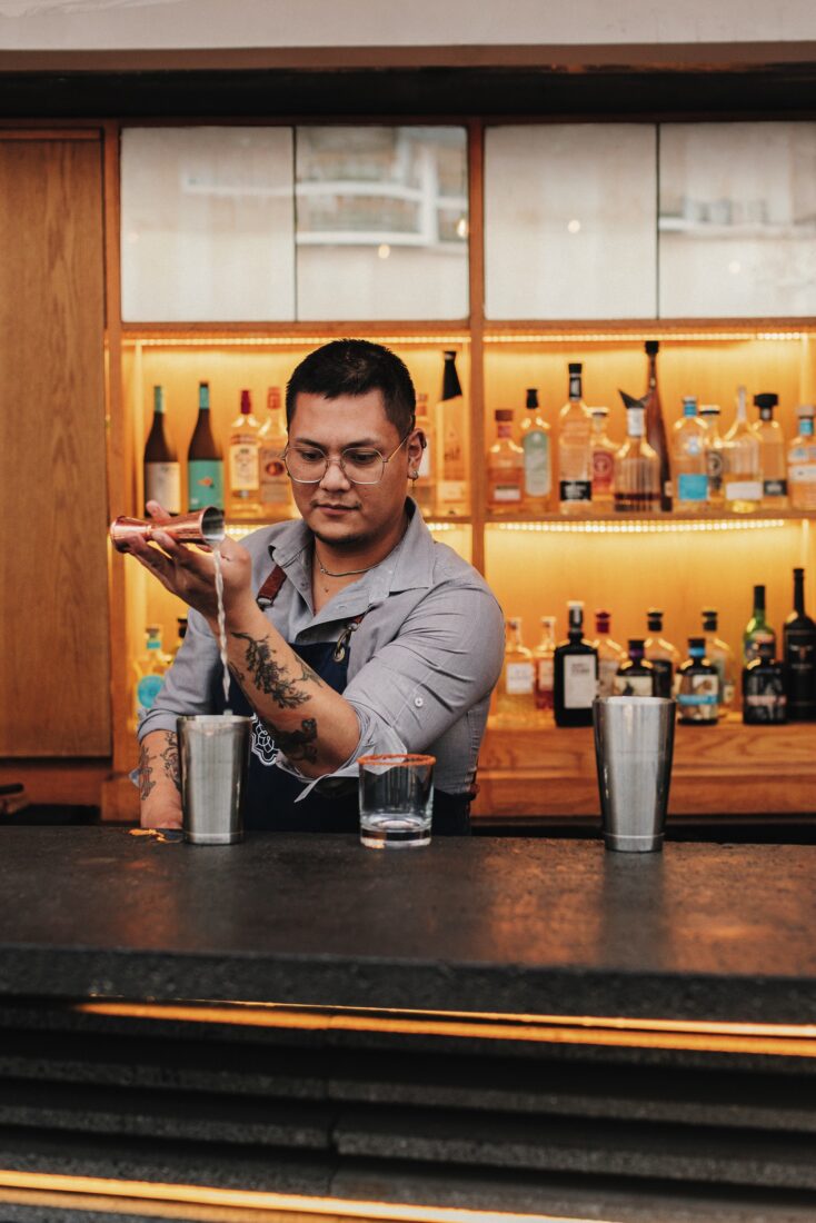A bartender makes a drink