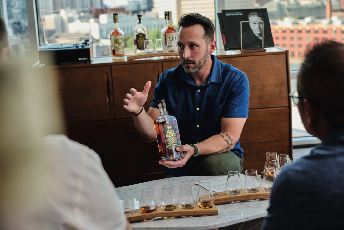 A man holds a bourbon bottle