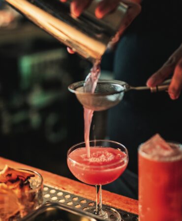 A red cocktail being poured