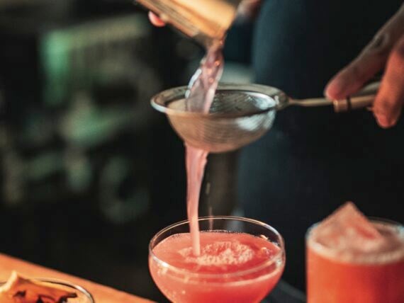 A red cocktail being poured