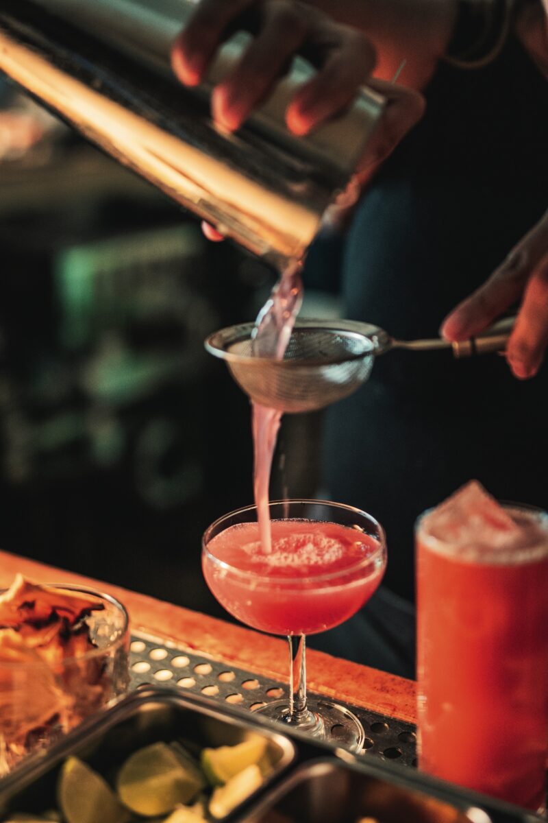 A red cocktail being poured