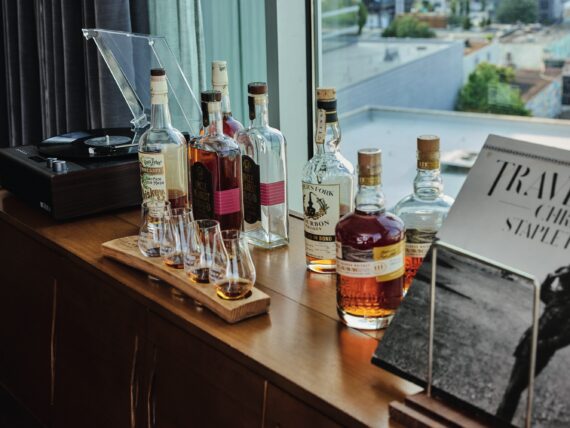 Bottles and a flight of whiskey on a table