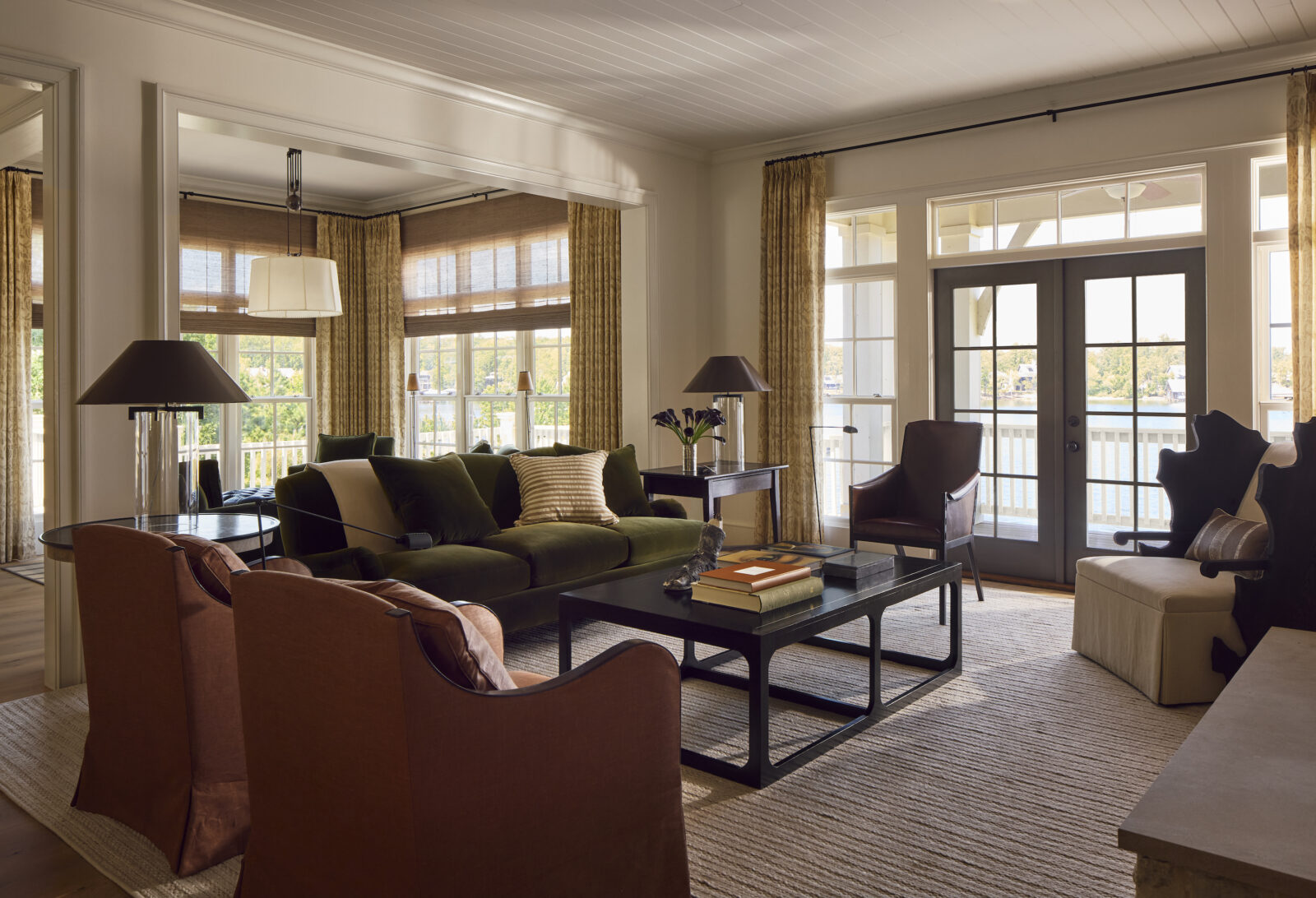 A living room with dark orange and green chairs