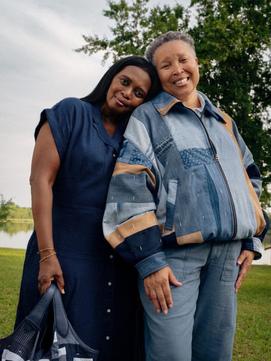 A portrait of two women; one wears a patchwork quilted jacket