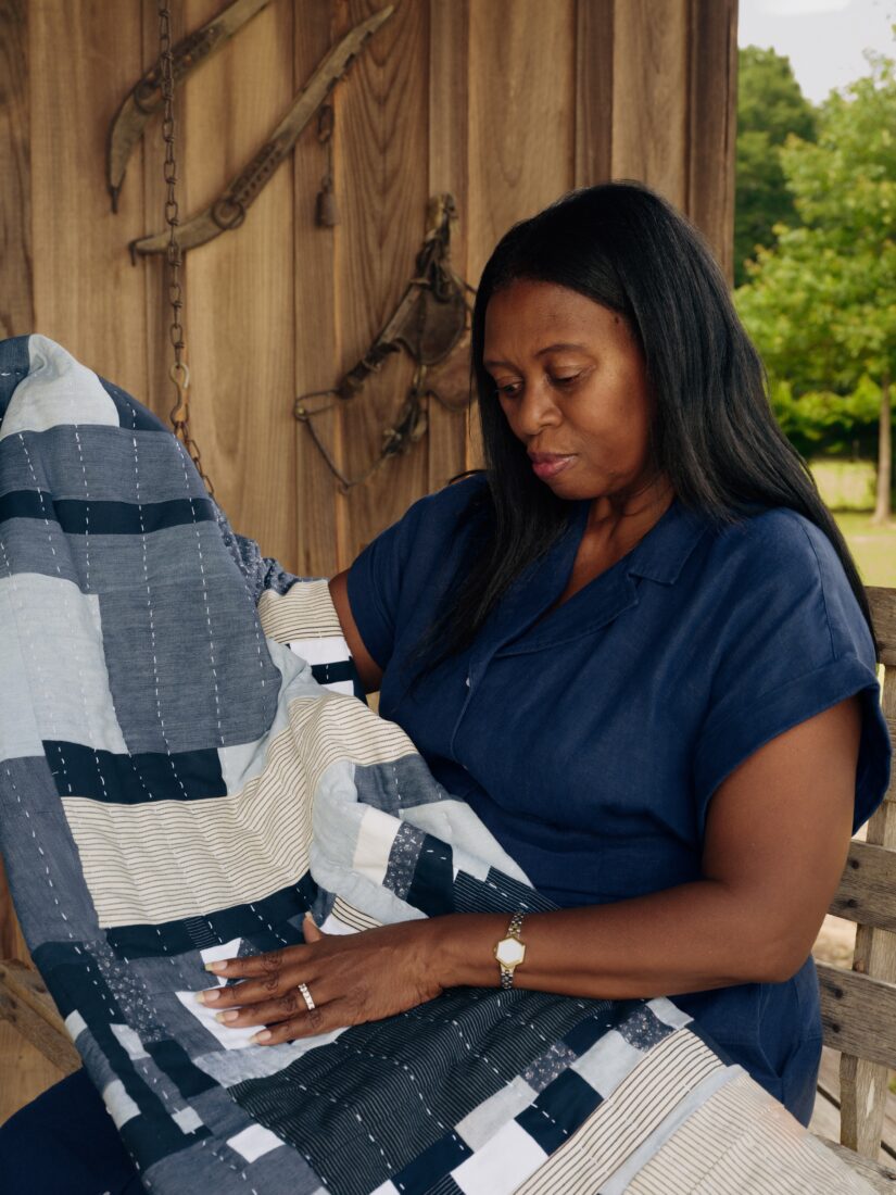 A portrait of a woman with a quilt