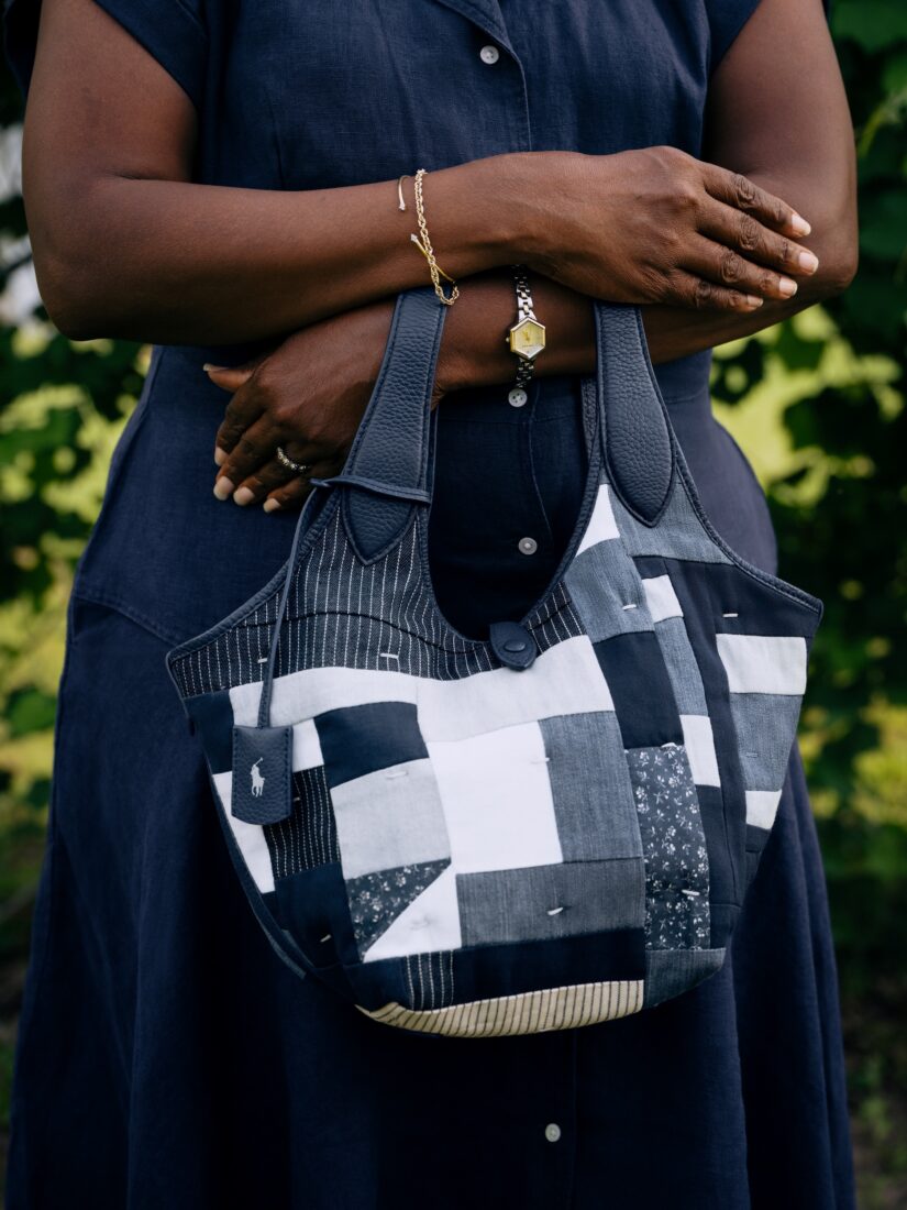 A woman holds a quilted bag