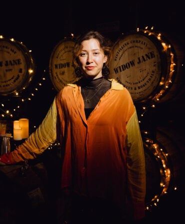 A woman in a distillery