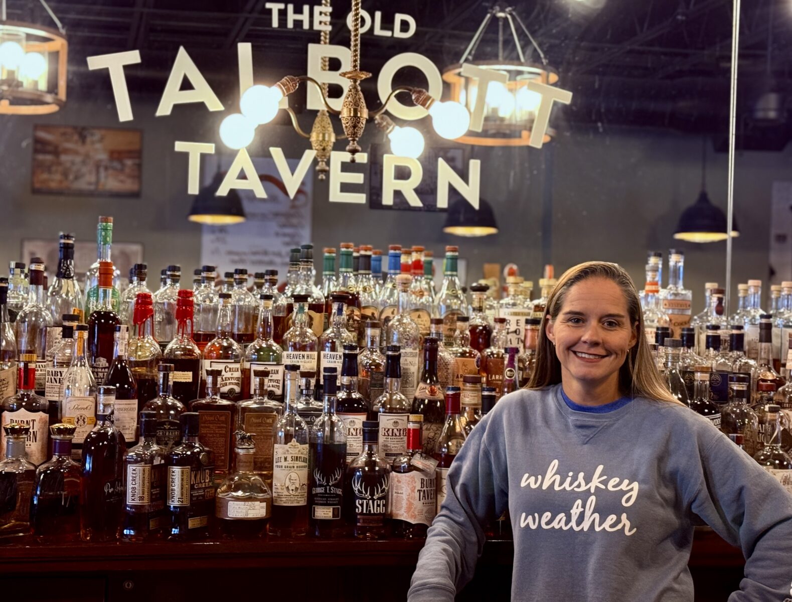 A woman in front of a bar