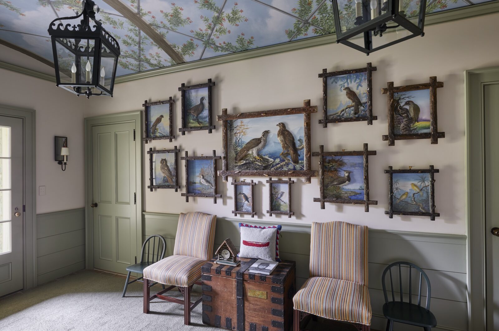 A room with bird artwork on the wall