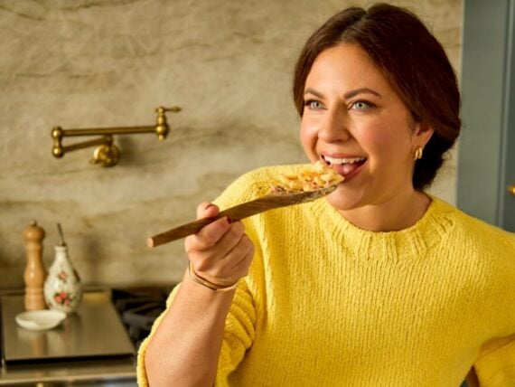 A woman eats mac and cheese