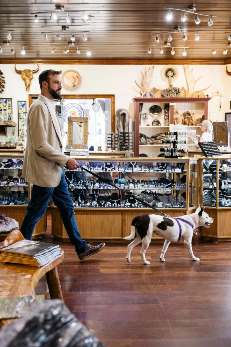 A man and dog inside a shop