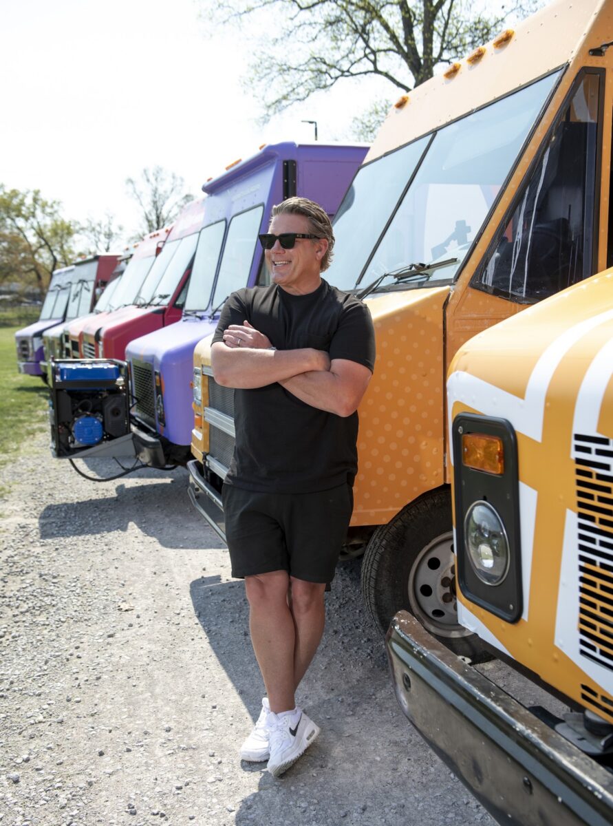A man leans against a food truck