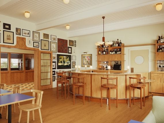 A restaurant interior with warm woods and many artworks on the wall