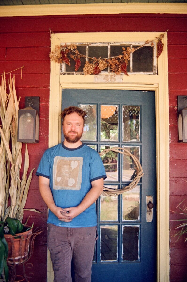 A portrait of a man on a porch