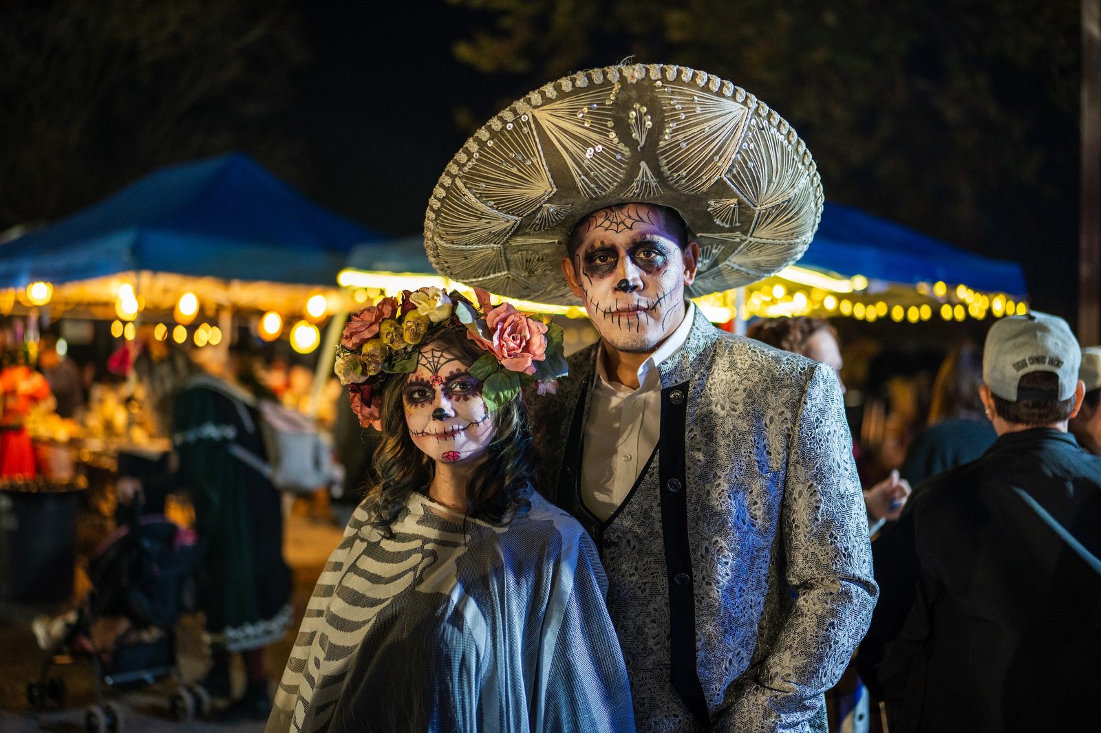 a costumed couple on day of the dead