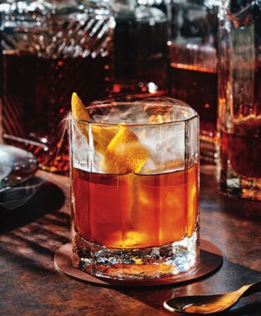 A bourbon cocktail with lemon garnish