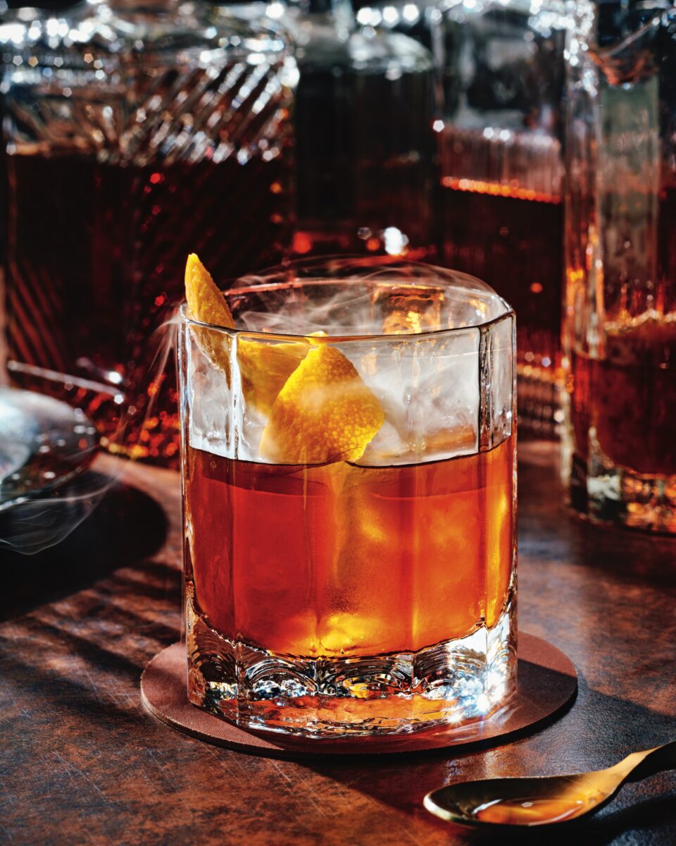 A bourbon cocktail with lemon garnish