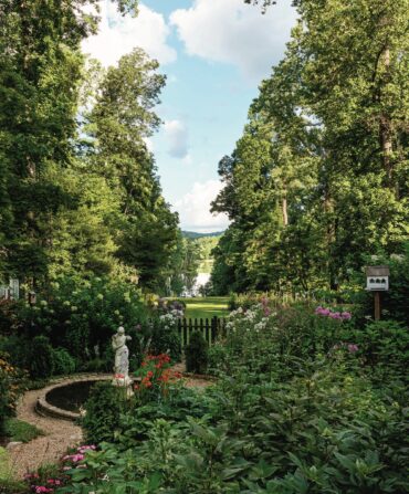A garden with a circular path and a statue