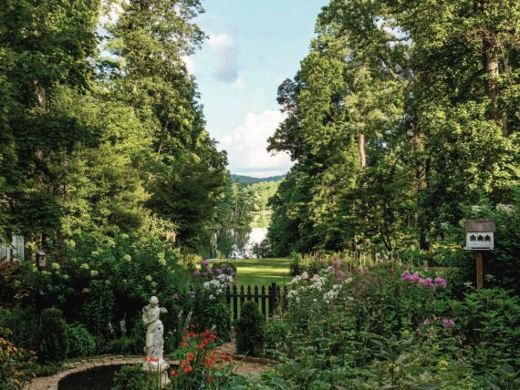 A garden with a circular path and a statue