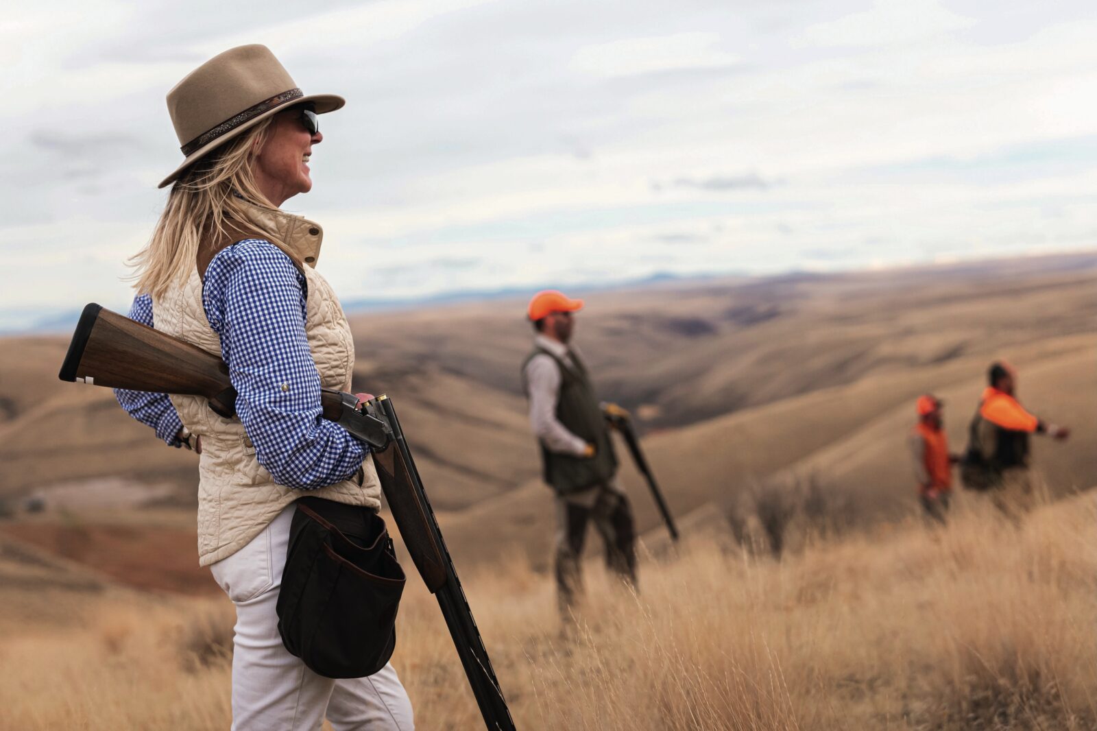 A woman hunting in a hilly field