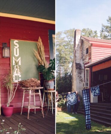 The front porch of a red, blue, and yellow cottage; indigo-dyed fabrics dry outside on a line.