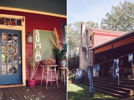 The front porch of a red, blue, and yellow cottage; indigo-dyed fabrics dry outside on a line.